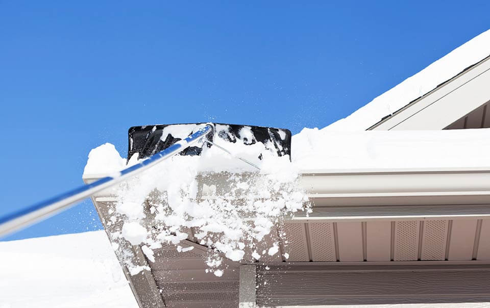 image of someone removing Snow from their Roof